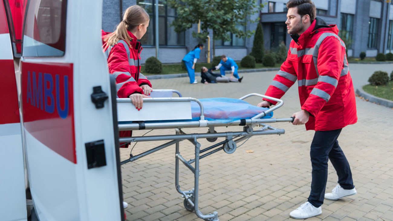 doctors taking ambulance stretcher to help wounded man